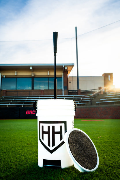 Home Run Hero Bucket and tee sitting in baseball field 