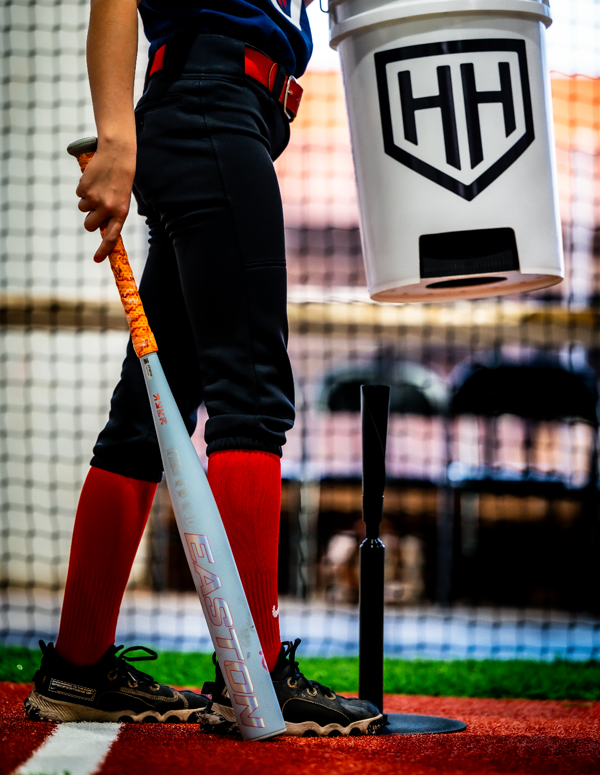 Home Run Hero baseball player setting down ball bucket 